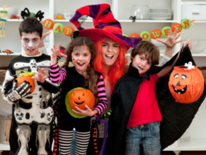 3 children and 1 adult dressed up for Halloween