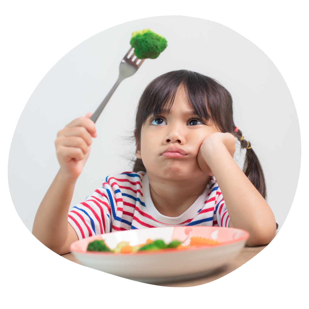 Child holding a fork with green vegetable on it, looking disgruntled